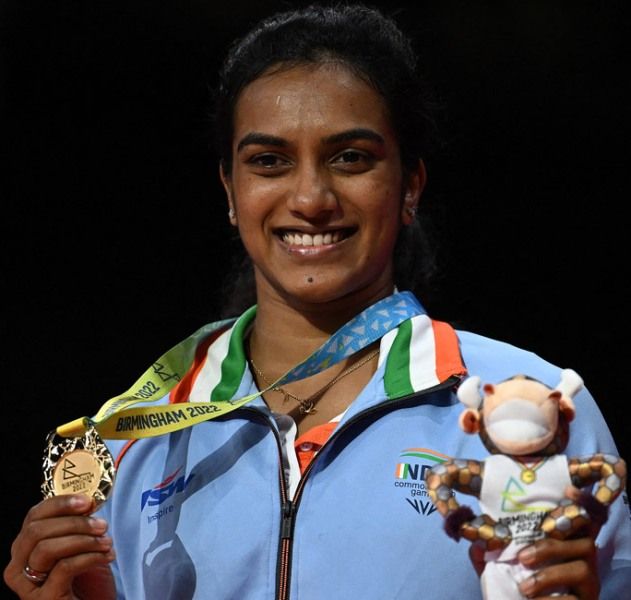 P V Sindhu proudly displays her gold medal