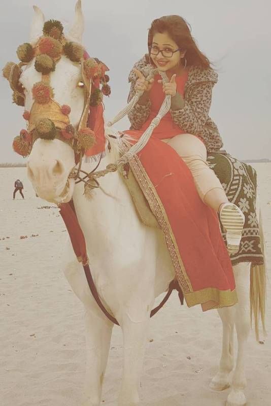 Sneh Upadhya riding a horse