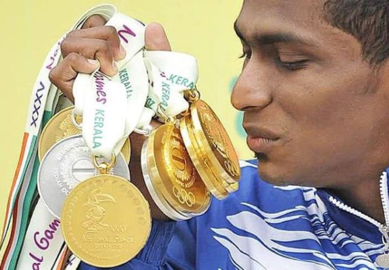 Sajan Prakash admiring his gold medals