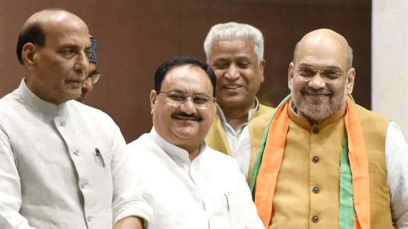 JP Nadda with Amit Shah right and Rajnath Singh left at the BJP central headquarters
