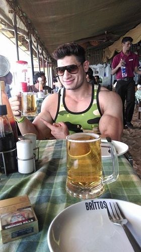 Manoj Patil holding a glass of beer