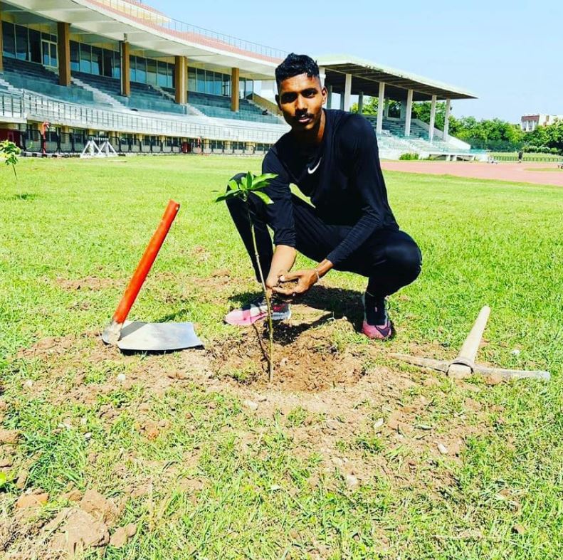 Nishad Kumar while planting a sapling