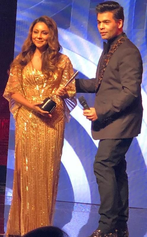 Gauri Khan receiving the Excellence Design Award from Karan Johar in 2018