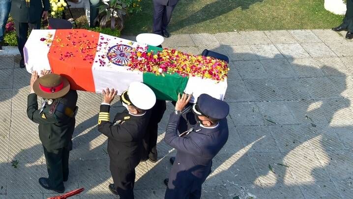 Tri-services officers carry the mortal remains of late Chief of Defence Staff (CDS) Gen Bipin Rawat during his funeral procession from his residence to Brar Square