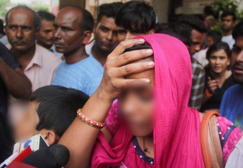 A relative of the Unnao rape survivor talks to the media outside KGMC Hospital where she was treated, in Lucknow