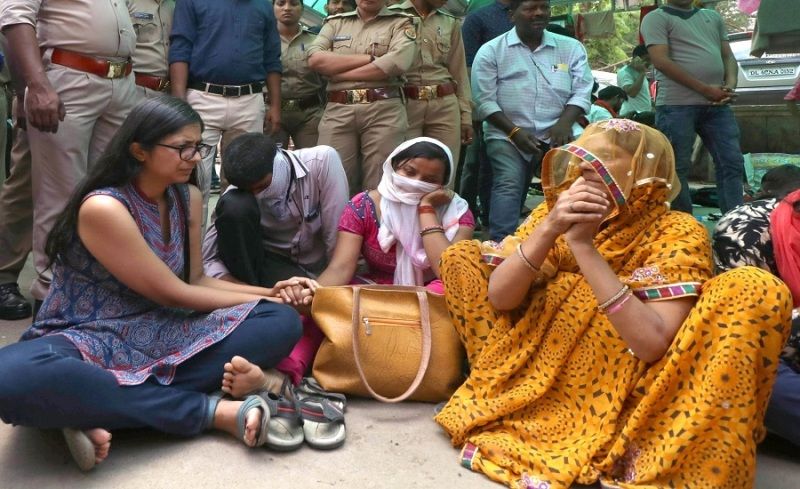 Delhi Commission for Women (DCW) Chairperson Swati Maliwal consoles the family members of Unnao rape survivor at the Trauma Centre of King George’s Medical University in Lucknow