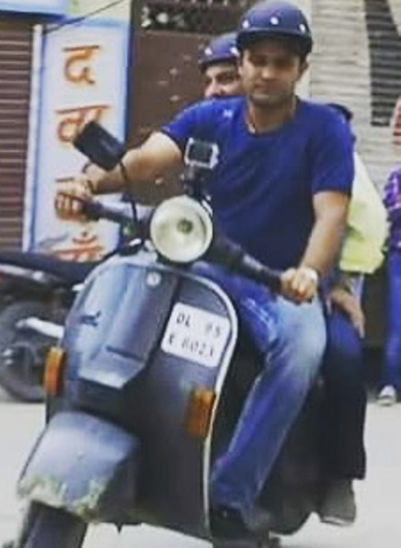 Virender Sehwag riding a scooter