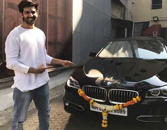 Kartik Aaryan with his BMW 5 Series car