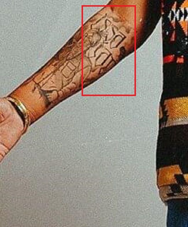Tattoo on his right forearm