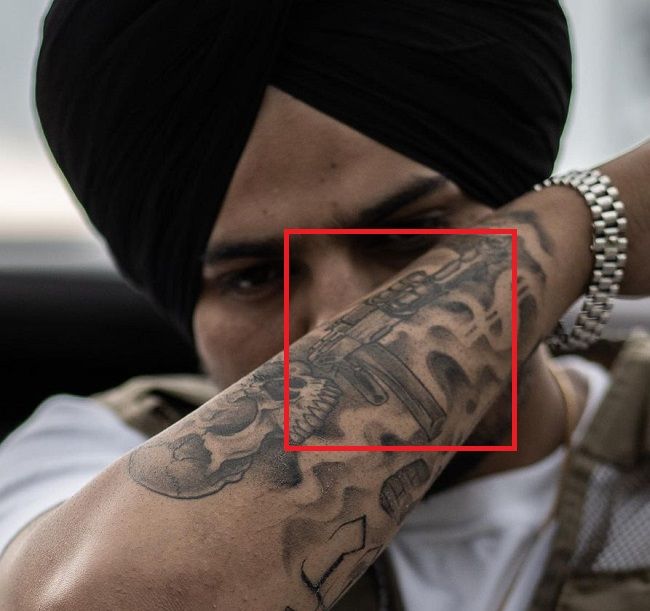 ‘Ak 47’ tattoo on his right forearm