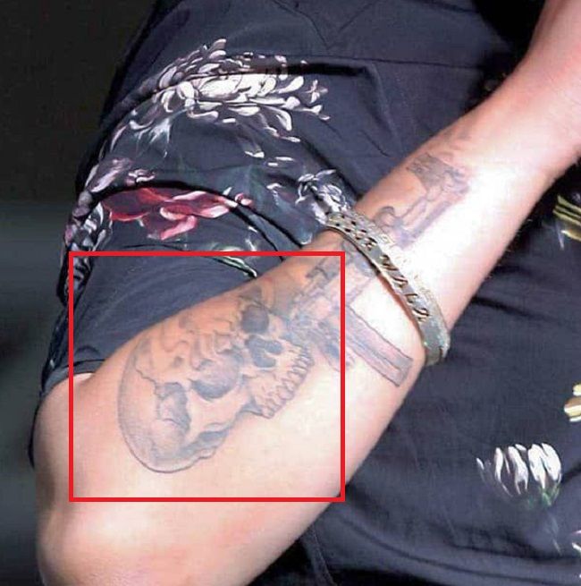 ‘Skull’ tattoo on his right forearm