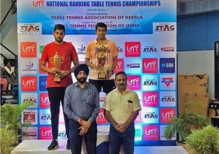 Harmeet Desai holding a trophy and a medal after winning the National Ranking Table Tennis Championship