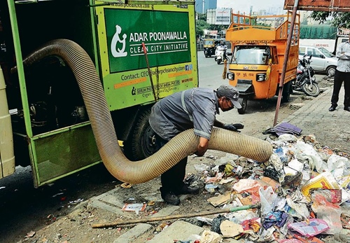 A worker cleaning garbage from the streets under the Adar Poonawalla Clean City initiative