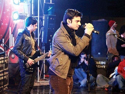 Fawad Khan performing on stage with his band