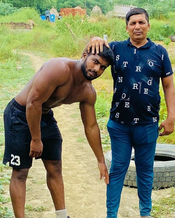 Ankit Baiyanpuria with his coach Krishan Pahalwan right