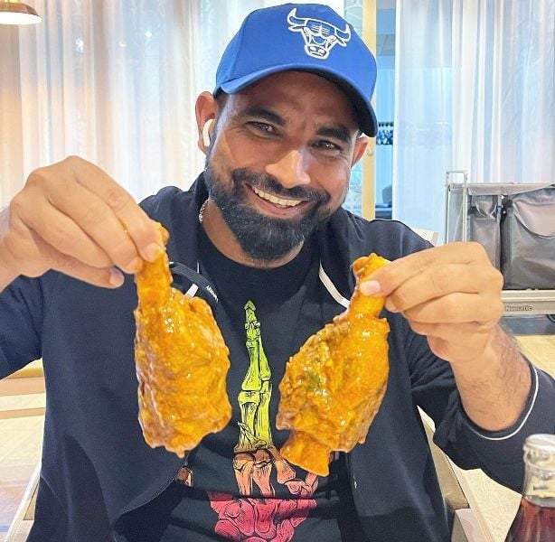 Mohammed Shami with chicken in his hand